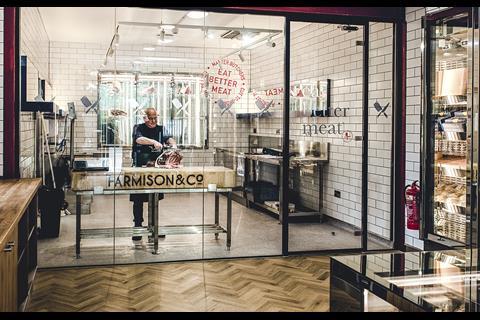 Butcher cutting ribs in Farmison & Co
